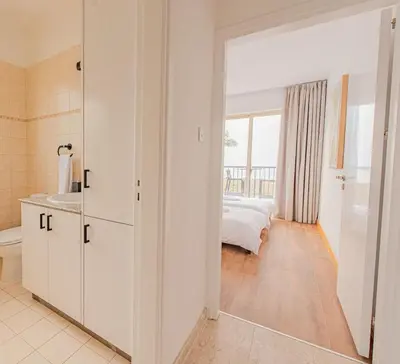 a bedroom with a bed and a mirror at TelMar Royal Villa Sea View in Mazotos