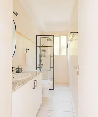 a white bathroom with a toilet and a sink at TelMar Royal Villa Sea View in Mazotos