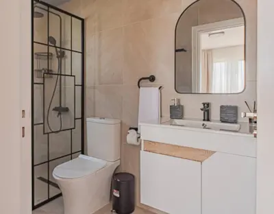 a bathroom with a toilet and a sink and a mirror at TelMar Royal Villa Sea View in Mazotos