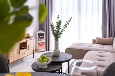 a living room with a couch and a table with a bowl of fruit at TelMar Sea View - 2 min walk to the Beach in Voroklini