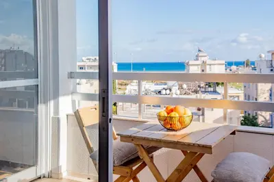 a bowl of fruit on a table on a balcony at TelMar City - Harbour Sea View from the Veranda in Larnaka