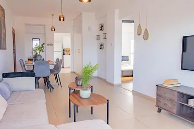 a living room with a couch and a table at TelMar City - Harbour Sea View from the Veranda in Larnaka