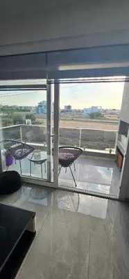 a room with a balcony with a view of an airport at Modern apartment in North Nicosia