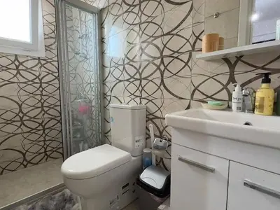 a bathroom with a toilet and a sink at Modern apartment in North Nicosia
