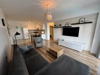 a living room with a couch and a brick wall at Caesar Resort Spa Long Beach