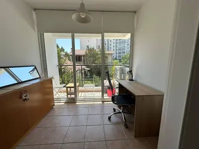 an office with a desk and a view of a balcony at Spacious City Center - Suite 203 in Nicosia