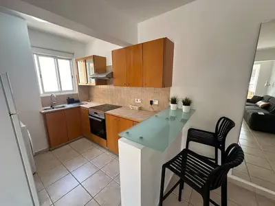 a kitchen with a counter and two chairs in it at Spacious City Center - Suite 203 in Nicosia