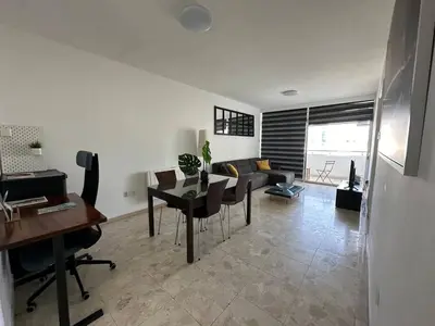a living room with a table and a couch at Suite 52 - Two Bedroom Apartment with Shared Pool in Nicosia