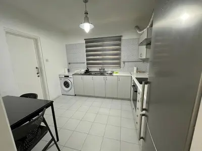 a kitchen with a refrigerator and a sink in it at Suite 52 - Two Bedroom Apartment with Shared Pool in Nicosia