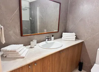 a bathroom with a sink and a mirror at Family House in Limassol