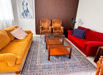 a living room with two couches and a coffee table at Family House in Limassol