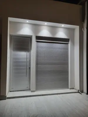 a room with two large windows with blinds at Chryso Apts Protaras in Paralimni
