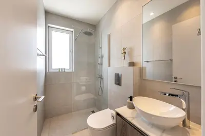 a white bathroom with a sink and a toilet at Protaras Leomi Seaview Villa in Protaras