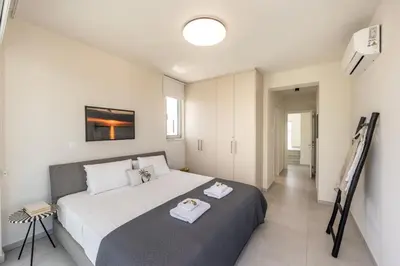 a bedroom with a large bed with towels on it at Protaras Leomi Seaview Villa in Protaras
