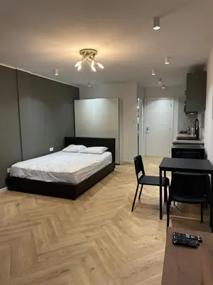 a bedroom with a bed and a table and chairs at Ayia Napa 1 Studio in Ayia Napa