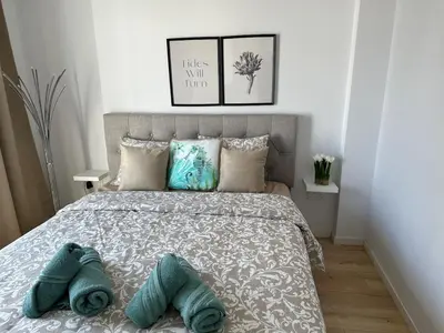 a bedroom with a bed with two pillows on it at Trinity Getaway in Paralimni