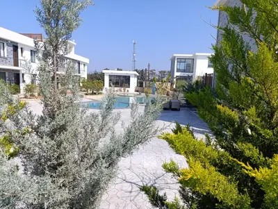 a view of a pool with trees and buildings at LJ Park Penthouse North Cyprus