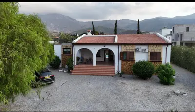 a small house with a car parked in front of it at A Spacious Villa to Entertain in Aglantzia