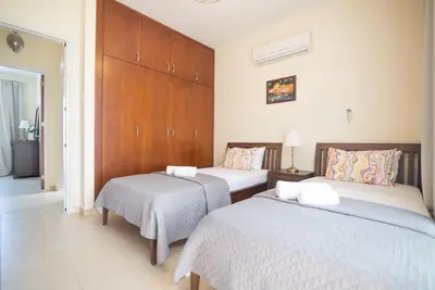 a bedroom with two beds with white sheets at Malama 2 Villa Ekaterina 2 bedroom in Paralimni