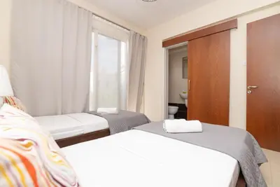 a hotel room with two beds and a window at Malama 2 Villa Ekaterina 2 bedroom in Paralimni