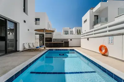a swimming pool in the backyard of a villa at Villa Alassia 16 by Ezoria Villas in Paralimni