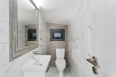 a bathroom with a toilet and a sink and a mirror at Villa Alassia 16 by Ezoria Villas in Paralimni