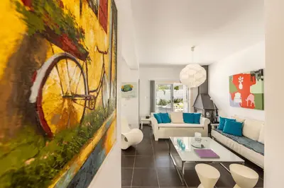 a living room with a bike painting on the wall at Protaras Seaside Villa Narcissos 16 in Protaras