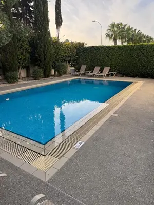 a swimming pool with chairs in a yard at Villa Samantha in Paralimni