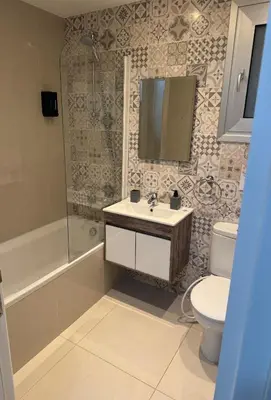a bathroom with a sink and a toilet and a shower at Villa Samantha in Paralimni