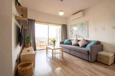 a living room with a couch and a large window at Central 1BR - Views - Deli Café in Nicosia