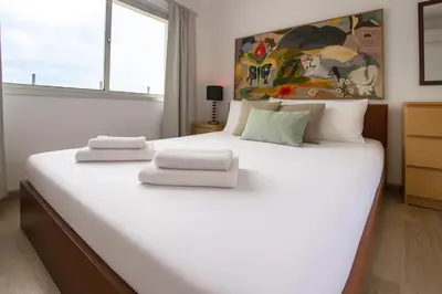 a large white bed in a room with a window at Central 1BR - Views - Deli Café in Nicosia