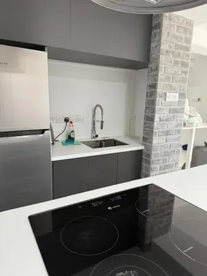 a kitchen with a sink and a black dishwasher at Marimar2 paradise by the Sea in Larnaka