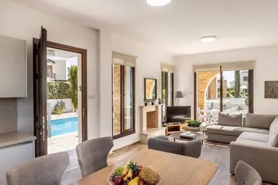 a living room with a table and a couch at Ionion H30 in Ayia Napa
