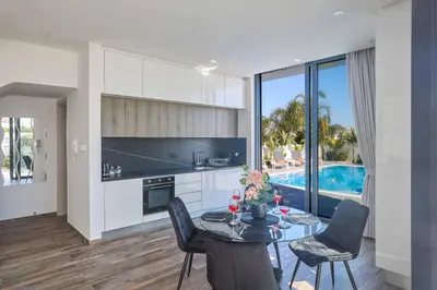 a kitchen and dining room with a table and chairs at Villa Almaria ALM28 in Protaras