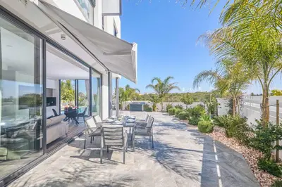 a patio with a table and chairs on a house at Villa Almaria ALM28 in Protaras