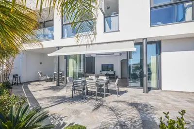 a patio with a table and chairs in front of a building at Villa Almaria ALM28 in Protaras