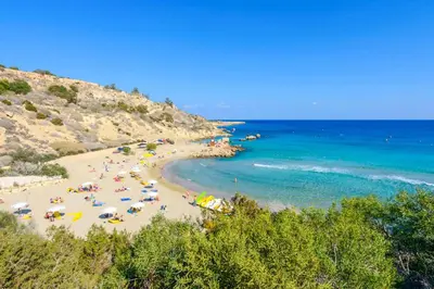 a beach with a bunch of people and the ocean at Green Bay Villa 15 in Protaras
