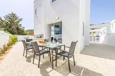 a table and chairs on the patio of a house at Green Bay Villa 15 in Protaras