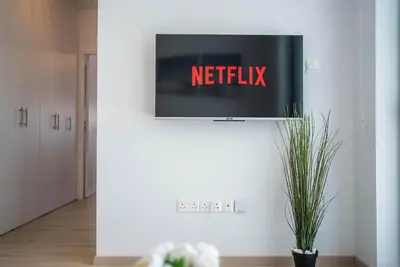 a tv on a wall with the netflix sign on it at CasaMar - Upscale One-Bedroom Apartment by the Sea in Larnaka