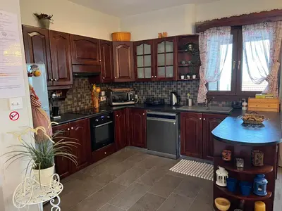 a kitchen with wooden cabinets and a blue counter top at Αετοφωλιά-AETOFOLIA in Pano Lefkara