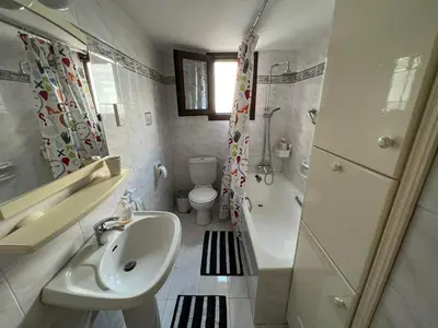 a bathroom with a sink and a toilet and a shower at Αετοφωλιά-AETOFOLIA in Pano Lefkara