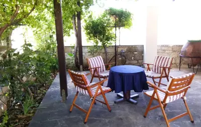 a patio with a table and four chairs at Revecca House in Ayios Mamas