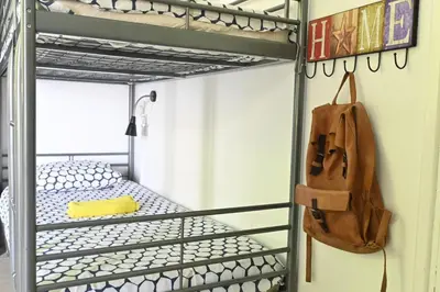 a metal bunk bed with a bag in a room at Lemongrass Hostel in Limassol