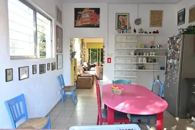 a dining room with a pink table and chairs at Lemongrass Hostel in Limassol