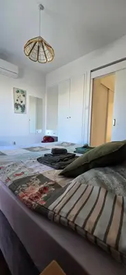 a bedroom with a bed with a blanket on it at Barefoot Beach House in Larnaka