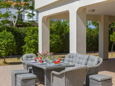 a table and chairs on a patio at Pervolia Nirides Seaside Mansion 7 in Larnaka