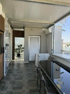 a kitchen with a table and chairs in a room at Costas court in Limassol