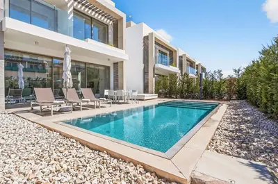 a swimming pool in the backyard of a house at Azure Leda Villa in Protaras