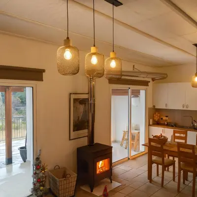 a kitchen with a wood stove in a room at Kalidoniahouses in Perapedhi