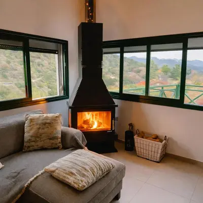 a living room with a couch and a fireplace at Kalidoniahouses in Perapedhi